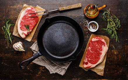 cast iron skillet with meat