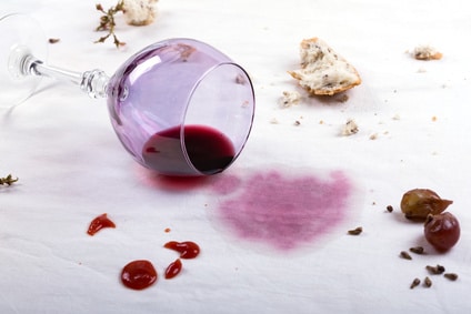 red wine spilled on a white table cloth