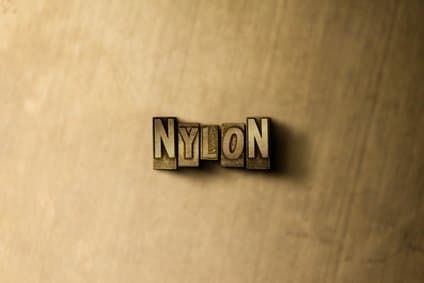 the word nylon with a wooden back drop