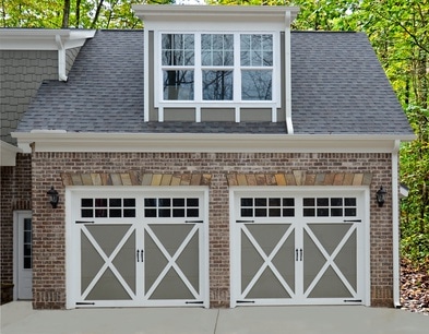 barn door garage with a roof