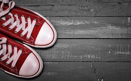 Rd converse sneakers on a wooden floor