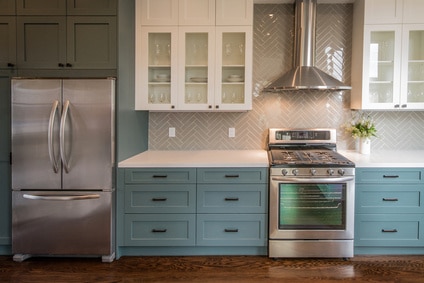 modern kitchen with stainless steel appliances and blue cabinets