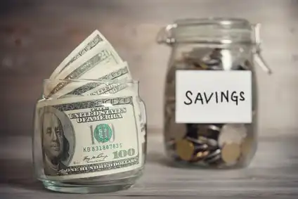 Two clear jars, one with cash the other with coin