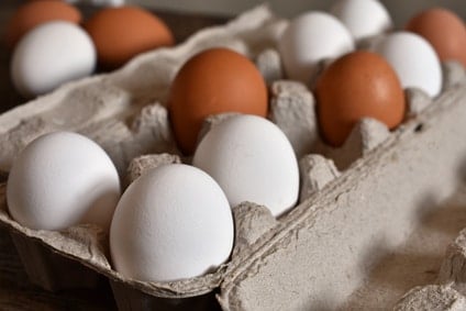 cardboard egg carton with multi colored fresh eggs