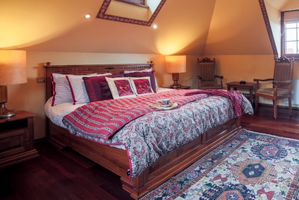 red and white bed with lots of pillows