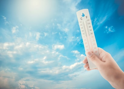 Woman hold a thermometer in the air