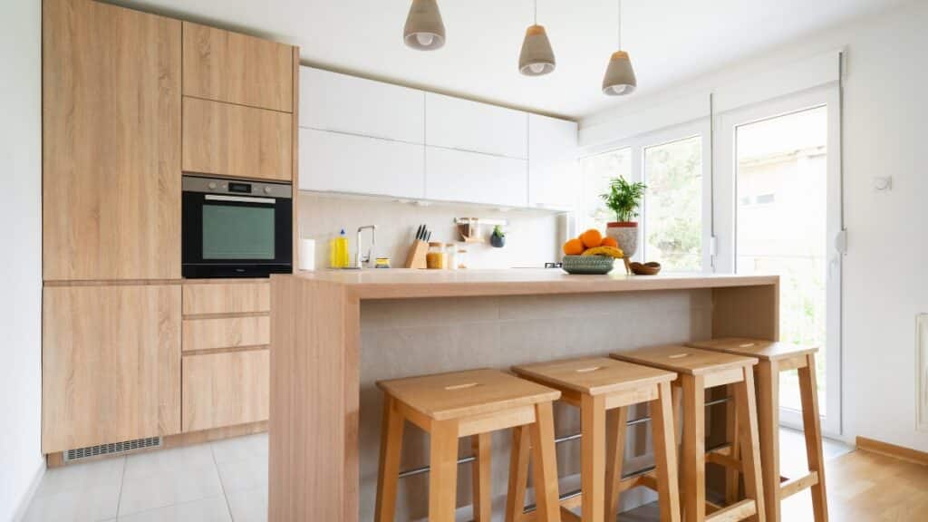 Deep cleaning service preparing a spotless modern kitchen with sanitized counters and polished wood surfaces