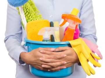 woman with cleaning supplies in a bucket